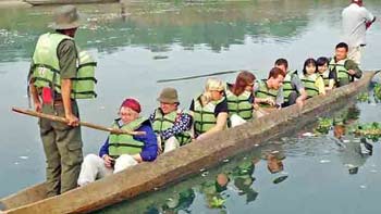 Visitors enjoying a peaceful canoe ride in Chitwan National Park